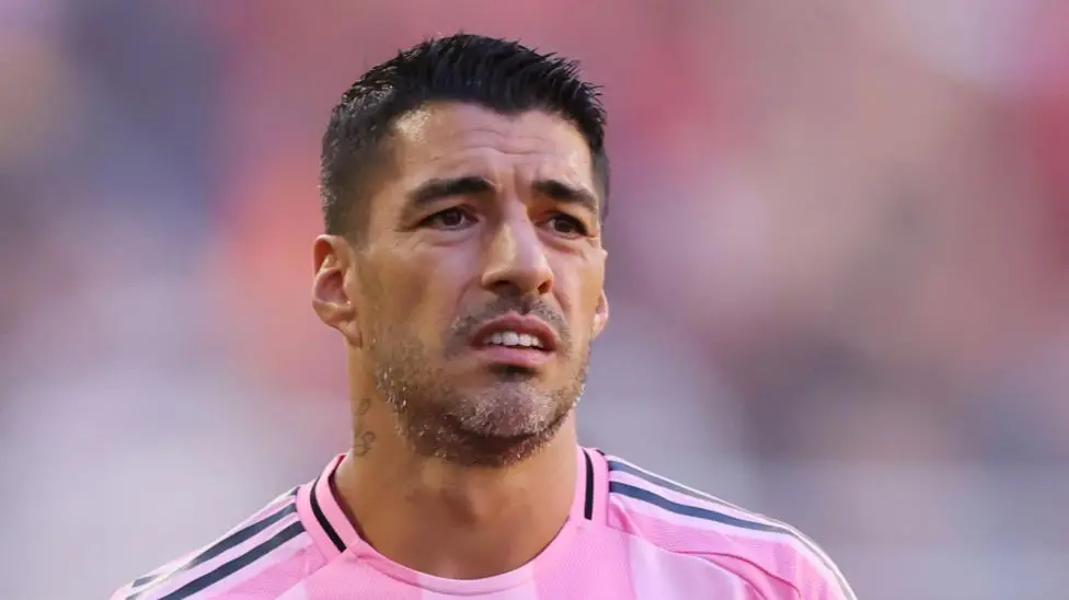 Suarez sorry for spitting at opposition coach